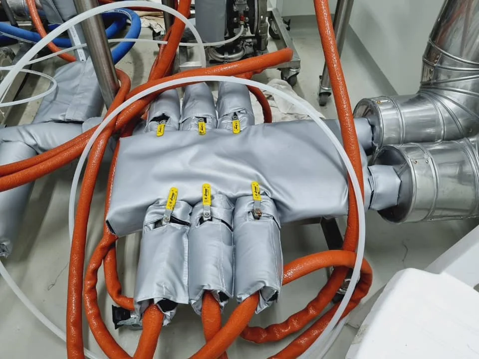 Removable insulation jacket installed on an industrial pipe manifold